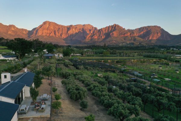 Ashia Center drone image with sunset on the surrounding mountains