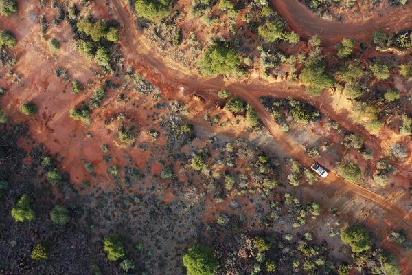 aerial image of a vehicle driving along a road